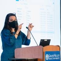 Speaker wearing mask giving closing statement.